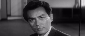 Black and white photograph of a man in a suit