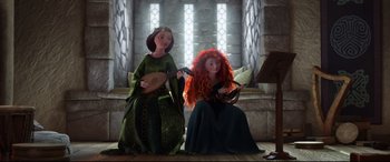 Movie still from “Brave” (2012), directed by Steve Purcell – A couple of women sitting next to each other on a floor; Wide shot, Low angle