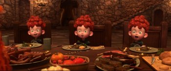 Movie still from “Brave” (2012), directed by Steve Purcell – A child sitting at a table with a plate of food on it; Wide shot, High angle