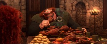 Movie still from “Brave” (2012), directed by Steve Purcell – A man in a kilt is eating food from a plate; Medium shot, High angle