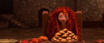 Movie still from “Brave” (2012), directed by Steve Purcell – A red haired woman with a plate of cookies; Medium shot, Overhead angle