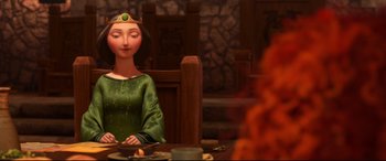 Movie still from “Brave” (2012), directed by Steve Purcell – A woman sitting at a table with a candle in front of her face; Medium shot, Over the shoulder angle