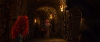 Movie still from “Brave” (2012), directed by Steve Purcell – A woman in a cave with a basket of fruit; Wide shot, Low angle