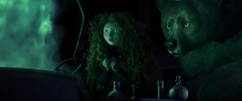 Movie still from “Brave” (2012), directed by Steve Purcell – A woman with long curly green hair standing next to a bear; Medium shot, Over the shoulder angle