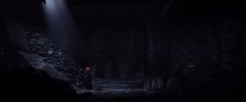 Movie still from “Brave” (2012), directed by Steve Purcell – A woman standing in front of a stone wall; Extreme Wide shot, High angle