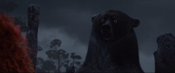 Movie still from “Brave” (2012), directed by Steve Purcell – A black bear is looking into the distance; Close Up shot, Low angle