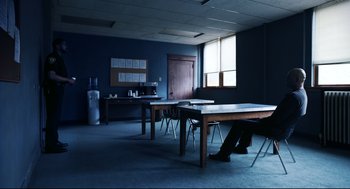 Movie still from “Brawl in Cell Block 99” (2017), directed by S. Craig Zahler – People sit at tables in an empty room; Wide shot, High angle