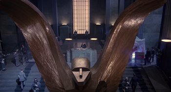 Movie still from “Brazil” (1985), directed by Terry Gilliam – A large sculpture of a bird in the middle of a room; Extreme Wide shot, Low angle