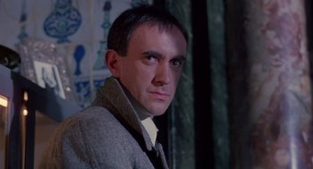 Movie still from “Brazil” (1985), directed by Terry Gilliam – A person wearing a jacket; Close Up shot, Low angle