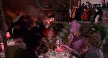 Movie still from “Brazil” (1985), directed by Terry Gilliam – A group of people sitting at a table with a candle; Medium shot, High angle