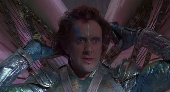 Movie still from “Brazil” (1985), directed by Terry Gilliam – A person wearing a suit of armor; Close Up shot, Low angle