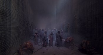 Movie still from “Brazil” (1985), directed by Terry Gilliam – A group of people in a dark room with smoke coming out of them; Extreme Wide shot, High angle