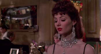 Movie still from “Brazil” (1985), directed by Terry Gilliam – A woman with red curly hair wearing a diamond necklace; Close Up shot, Over the shoulder angle