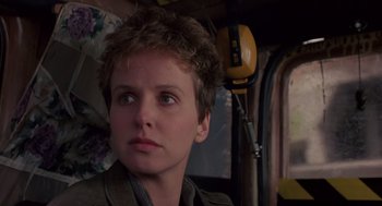 Movie still from “Brazil” (1985), directed by Terry Gilliam – A young man with a short haircut looking to his left; Close Up shot, Low angle