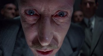 Movie still from “Brazil” (1985), directed by Terry Gilliam – A man's face with blue eyes; Extreme Close Up shot, Low angle