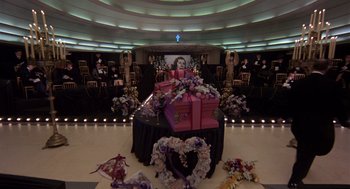 Movie still from “Brazil” (1985), directed by Terry Gilliam – A room with a lot of flowers on the floor; Wide shot, High angle