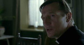 Movie still from “Breakfast on Pluto” (2005), directed by Neil Jordan – A person wearing a priest's collar; Close Up shot, Over the shoulder angle