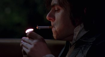 Movie still from “Breakfast on Pluto” (2005), directed by Neil Jordan – A man is smoking a cigarette in the dark; Close Up shot, Low angle