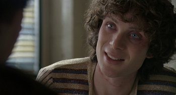 Movie still from “Breakfast on Pluto” (2005), directed by Neil Jordan – A person smiling; Close Up shot, Over the shoulder angle