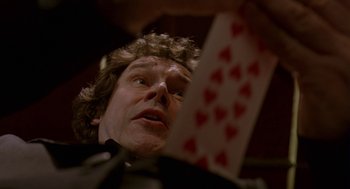 Movie still from “Breakfast on Pluto” (2005), directed by Neil Jordan – A person holding a deck of playing cards; Extreme Close Up shot, Overhead angle