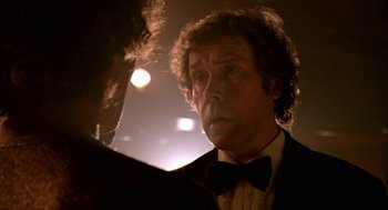 Movie still from “Breakfast on Pluto” (2005), directed by Neil Jordan – A person wearing a suit and bow tie; Close Up shot, Low angle