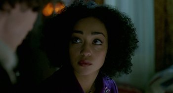 Movie still from “Breakfast on Pluto” (2005), directed by Neil Jordan – A person wearing a purple shirt; Close Up shot, Over the shoulder angle