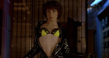 Movie still from “Breakfast on Pluto” (2005), directed by Neil Jordan – A woman in a black and yellow outfit; Medium shot, Overhead angle