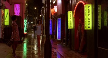 Movie still from “Breakfast on Pluto” (2005), directed by Neil Jordan – A woman walking down a street at night; Wide shot, High angle