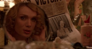 Movie still from “Breakfast on Pluto” (2005), directed by Neil Jordan – A person looking at a newspaper; Close Up shot, Over the shoulder angle