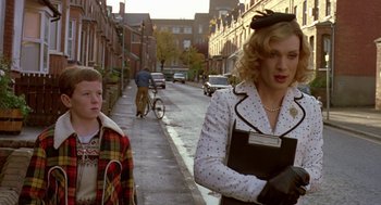 Movie still from “Breakfast on Pluto” (2005), directed by Neil Jordan – A man and a woman walking down a street; Medium shot, Low angle