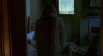 Movie still from “Breakfast on Pluto” (2005), directed by Neil Jordan – A woman in a fur coat looking out a window; Medium shot, Over the shoulder angle