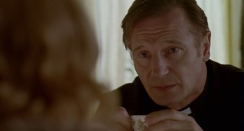 Movie still from “Breakfast on Pluto” (2005), directed by Neil Jordan – A person holding a cup of coffee; Close Up shot, Over the shoulder angle