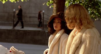 Movie still from “Breakfast on Pluto” (2005), directed by Neil Jordan – A woman in a white coat and a brown hat; Medium shot, Over the shoulder angle