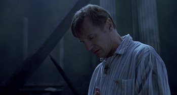 Movie still from “Breakfast on Pluto” (2005), directed by Neil Jordan – A man in striped shirt looking down at his chest; Close Up shot, Low angle