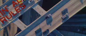 Movie still from “Breakin' All the Rules” (2004), directed by Daniel Taplitz – An aerial view of a highway with cars driving on it; Extreme Wide shot, Overhead angle