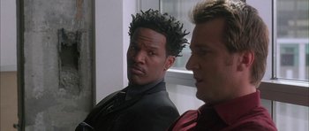 Movie still from “Breakin' All the Rules” (2004), directed by Daniel Taplitz – Two men in suits are looking at each other; Close Up shot, Over the shoulder angle