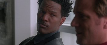 Movie still from “Breakin' All the Rules” (2004), directed by Daniel Taplitz – A person wearing a suit and tie; Close Up shot, Over the shoulder angle