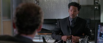 Movie still from “Breakin' All the Rules” (2004), directed by Daniel Taplitz – A man wearing a suit and tie talking to another man in front of a mirror; Close Up shot, Over the shoulder angle