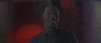 Movie still from “Breakin' All the Rules” (2004), directed by Daniel Taplitz – A man in a black dress shirt is smiling; Close Up shot, Low angle