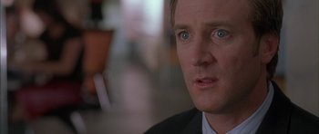 Movie still from “Breakin' All the Rules” (2004), directed by Daniel Taplitz – A person wearing a suit and tie; Close Up shot, Over the shoulder angle