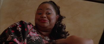 Movie still from “Breakin' All the Rules” (2004), directed by Daniel Taplitz – A person wearing a floral shirt; Close Up shot, Low angle