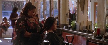 Movie still from “Breakin' All the Rules” (2004), directed by Daniel Taplitz – A woman getting her hair cut at a hair salon; Medium shot, Over the shoulder angle