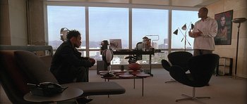 Movie still from “Breakin' All the Rules” (2004), directed by Daniel Taplitz – Two people are sitting in a room with a view of a city; Wide shot, High angle