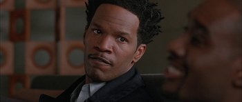 Movie still from “Breakin' All the Rules” (2004), directed by Daniel Taplitz – A person wearing a suit and tie; Close Up shot, Over the shoulder angle