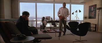 Movie still from “Breakin' All the Rules” (2004), directed by Daniel Taplitz – A group of people sitting in a living room; Wide shot, High angle