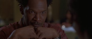 Movie still from “Breakin' All the Rules” (2004), directed by Daniel Taplitz – A person with his hand on his chin; Close Up shot, Low angle