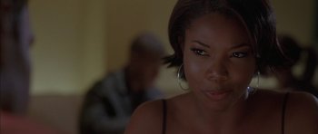 Movie still from “Breakin' All the Rules” (2004), directed by Daniel Taplitz – A woman's face in a dark room; Close Up shot, Over the shoulder angle
