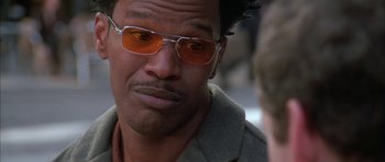 Movie still from “Breakin' All the Rules” (2004), directed by Daniel Taplitz – A person wearing orange sunglasses; Close Up shot, Over the shoulder angle
