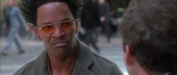 Movie still from “Breakin' All the Rules” (2004), directed by Daniel Taplitz – A person wearing a jacket and sunglasses; Close Up shot, Over the shoulder angle