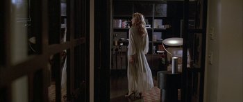 Movie still from “Breakin' All the Rules” (2004), directed by Daniel Taplitz – A woman in a white dress walking through a room; Wide shot, Over the shoulder angle